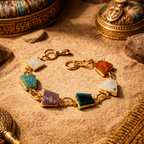 Gold bracelet with colorful stones on a textured surface with decorative elements
